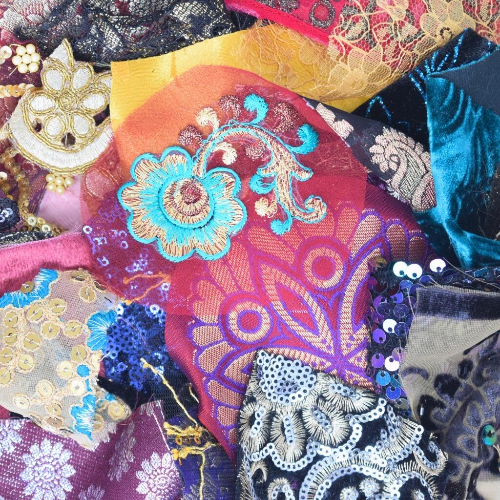 Close up detail of some embellished craft fabric scraps in opulent and luxurious colours
