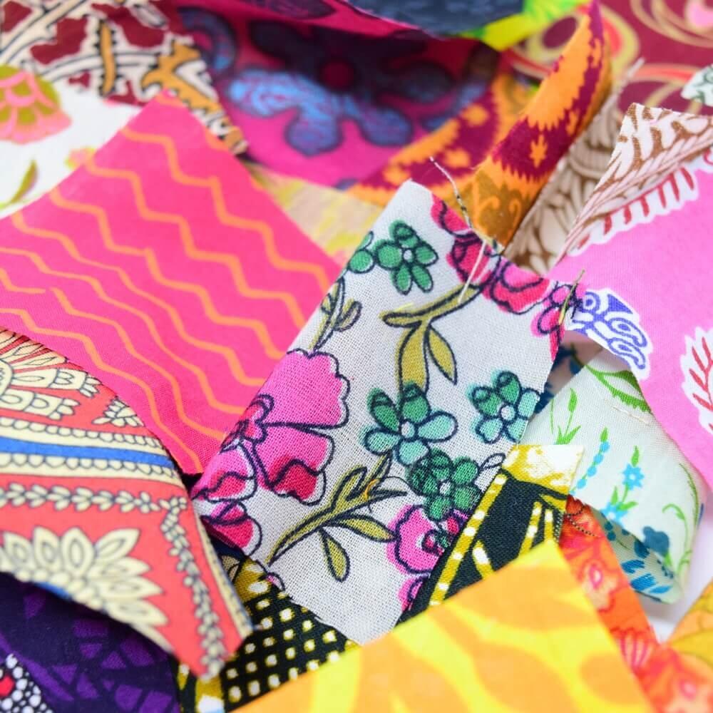 Close up detail of some ethnic print fabric pieces showing pattern detail in bright colours