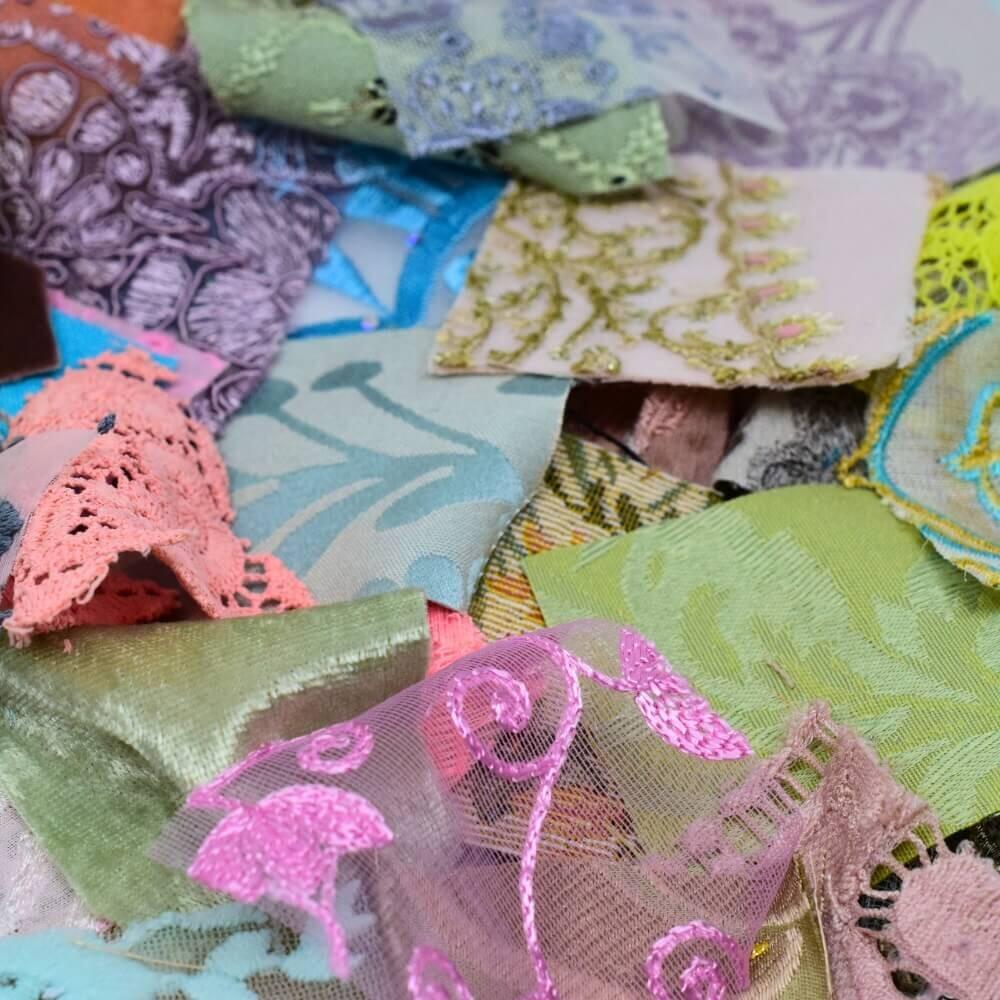 close up detail of assorted fabric squares showing the various textures and colours