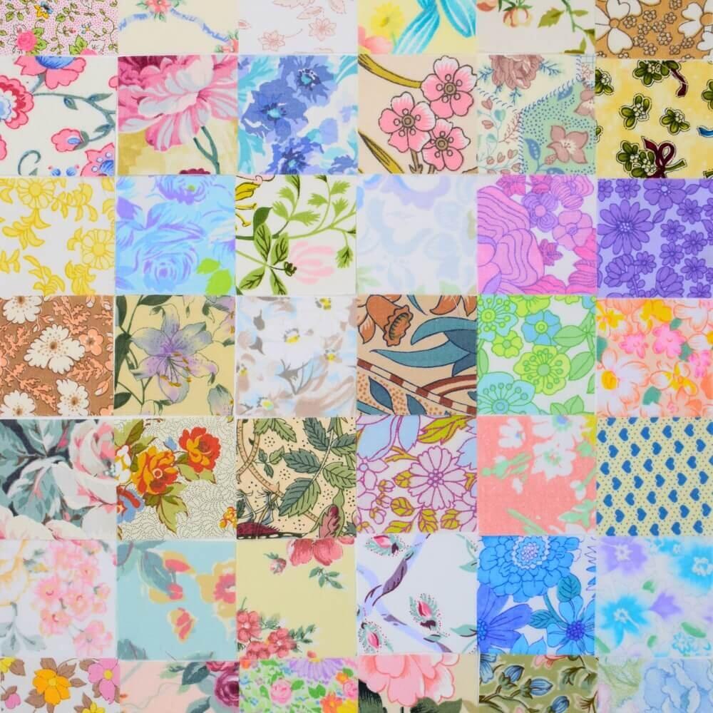 Flat lay of a selection of vintage floral fabric squares arranged in a patchwork quilt style pattern