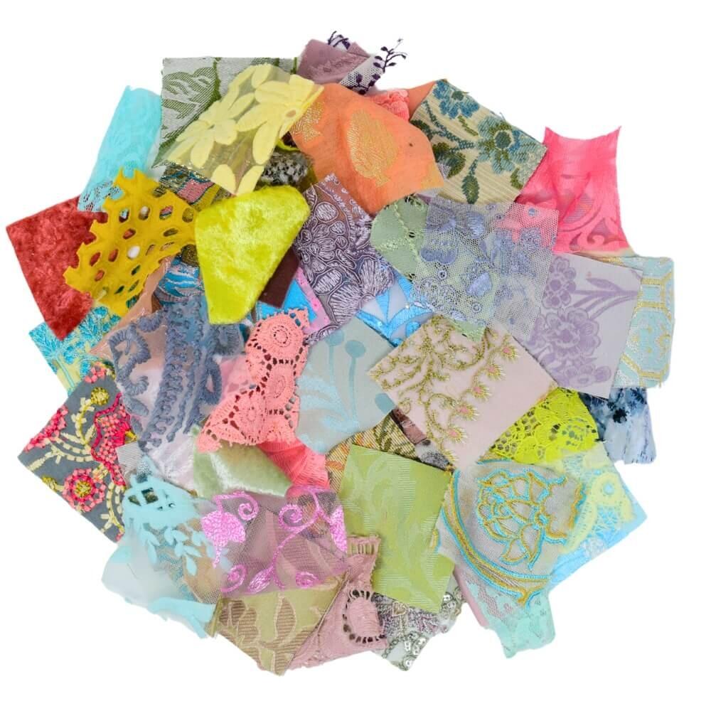 flat lay of a selection of pastel coloured textured fabric squares arranged in a rough circular shape on a white background