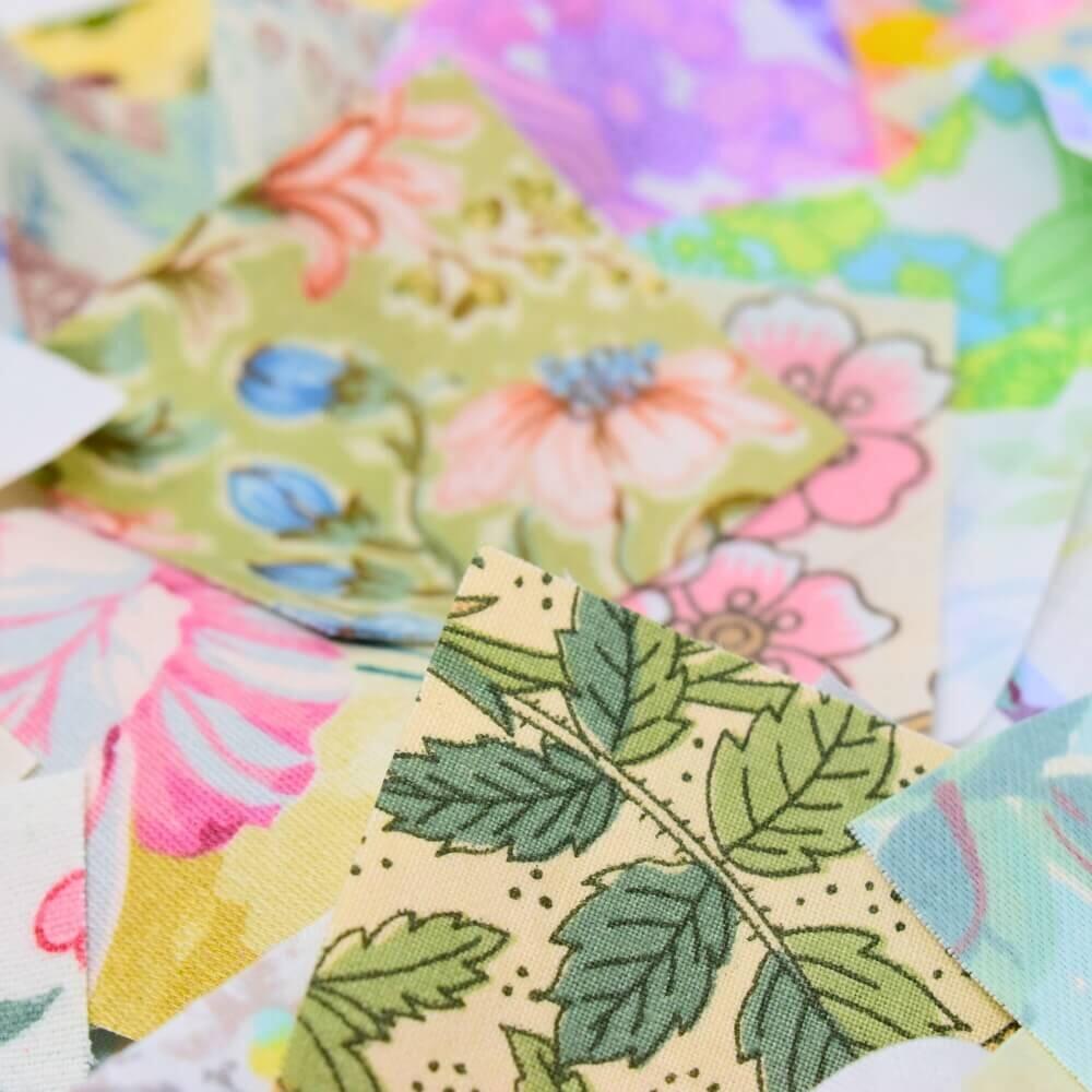 Close up detail of some floral fabric pieces showing petal and leaf detail in pretty colours