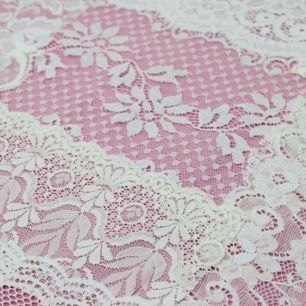 Close up of the detail and patterns on some pieces of white lace fabrics and trim