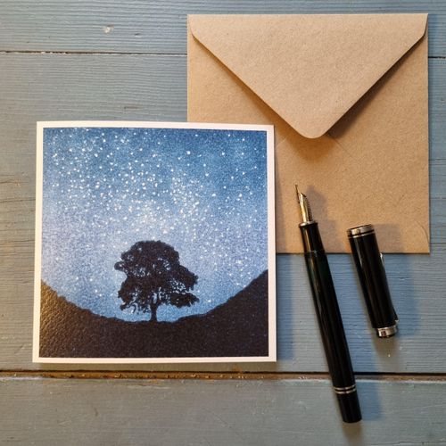 reproduction card of the Sycamore Gap tree under a starry night sky
