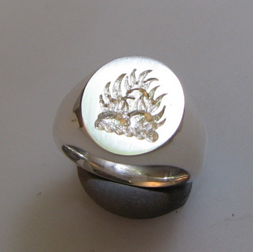 Burning rocks crest engraved silver signet ring