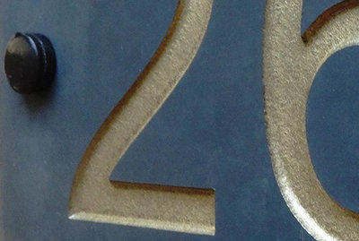 Example illustrating a slate house sign with a number 24 produced by a sandblasting method