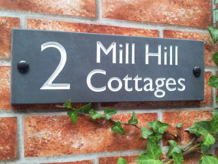 Slate house sign with large number and address line and white inlay
