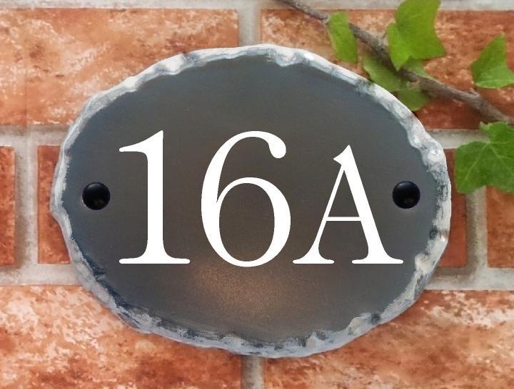 Oval house number plaque in rustic style with 16A