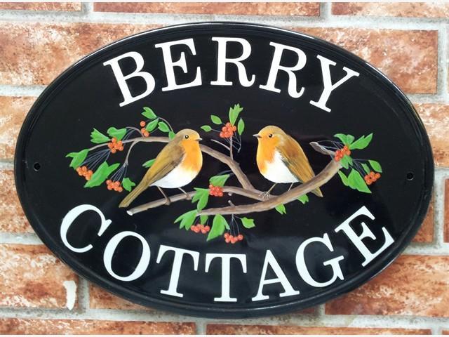 Two robins on branch sign