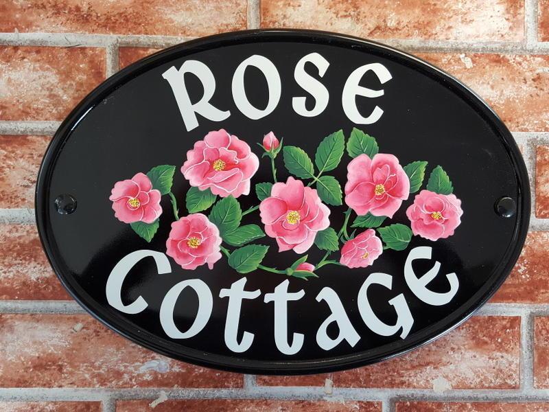 Hand painted house sign depicting pink roses and the house name Rose Cottage