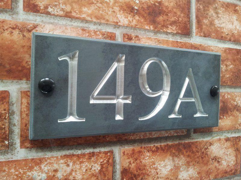 Slate number sign displaying 149A with chromed silver inlay