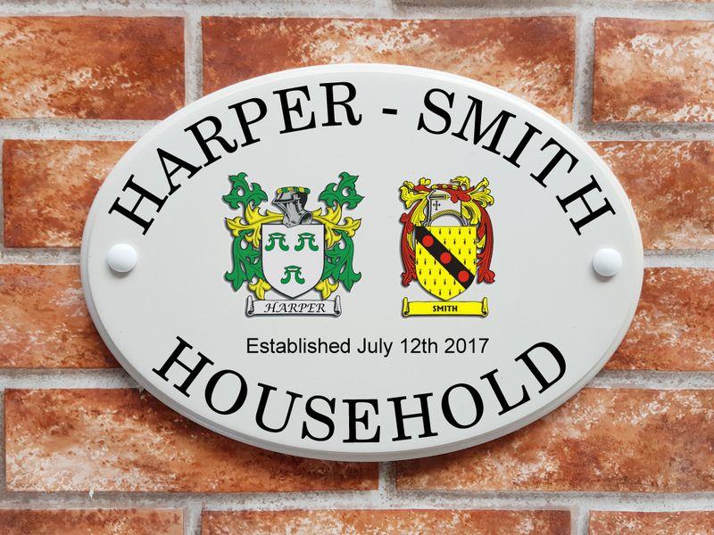house sign with 2 family crests