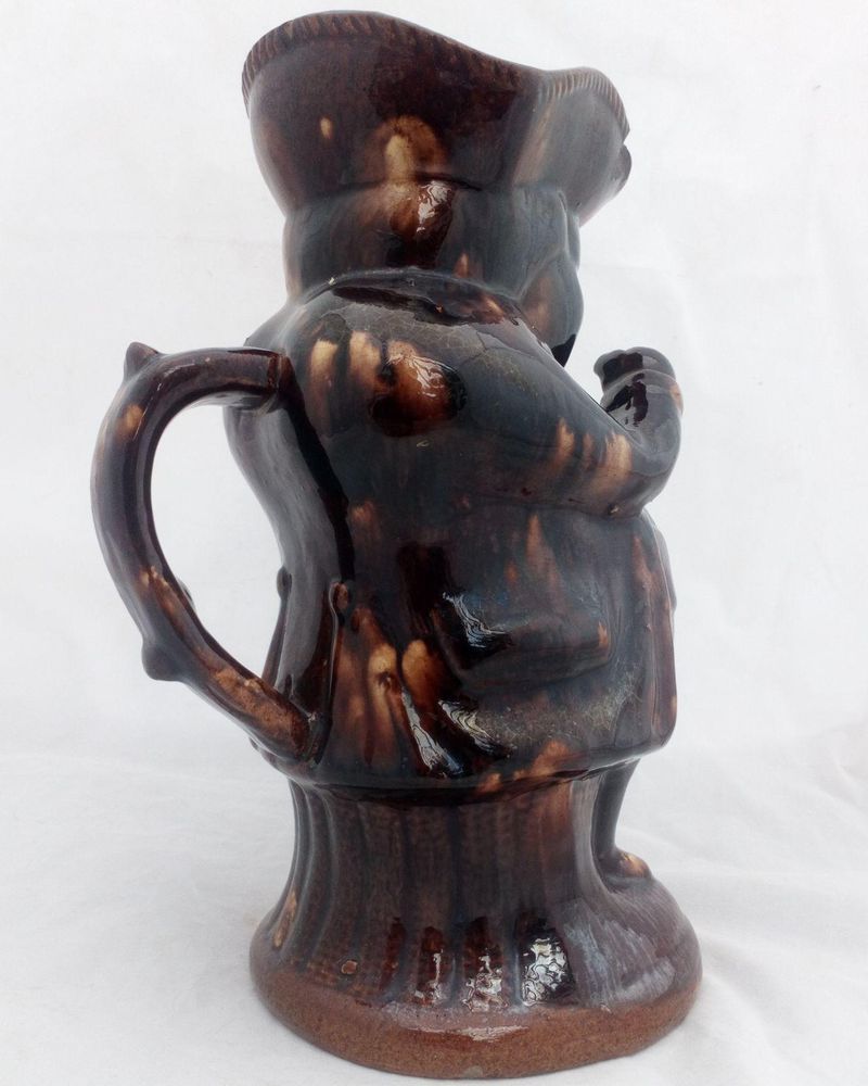 Antique pottery Rockingham brown treacle glazed toby jug known as the Snuff Taker 24 cm high dating from the 19th century circa 1880.
