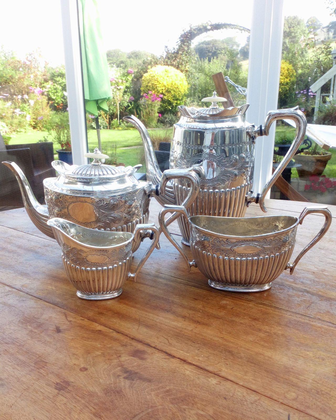 An antique late Victorian silver plated four piece tea and coffee set or service new oval shape reeded and engraved bodies teapot inscribed to one side 1st prize presented by J Ashworths and sons ltd  rodsham Bridge stamped on the base GM&S 770 for George Maclaurin and Co of Sheffield circa 1900.
