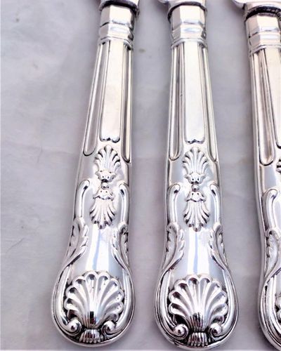An antique set of twelve place setting of Elkington silver plated cutlery with Kings pattern handles. The round nosed bladed knives and the four pronged forks are each marked with the Elkington and Co marks and the date code W for 1882.