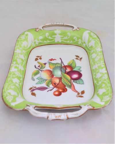 Antique New Hall Porcelain rectangular twin handled dessert dish with low relief rim of birds and fruiting vines on a light green ground. It has a central transfer printed and hand coloured fruit decoration , made in the Georgian period circa 1820 to 1831.