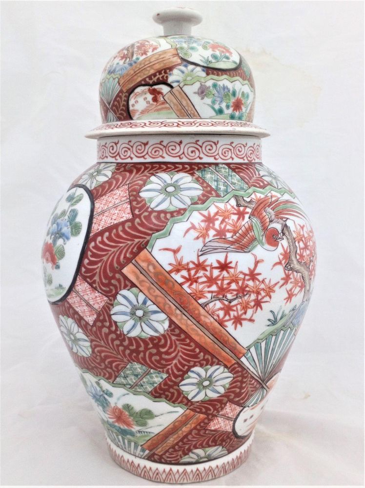 A large antique Japanese Hizen porcelain vase and cover marked Zoshuntei Saiho. Decorated in hand painted enamels with two large Japanese folding fans each painted with a colourful Asiatic Pheasant flying over a Japanese Acer.  This antique temple vase and cover dates from the mid 19th century circa 1860.