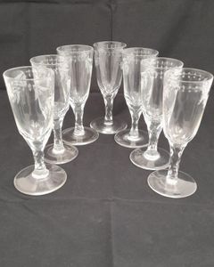 Antique set of seven Georgian style tall round funnel bowl flutes on diamond faceted stems and plain feet. The bowls wheel engraved with OXO and floral swags. Antique Ale Glasses or Champagne Flutes circa 1890