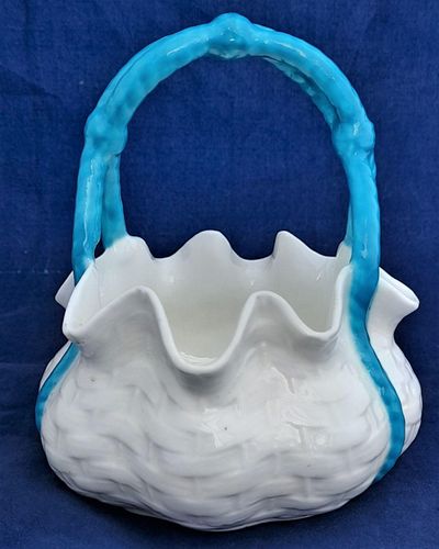 An antique moulded porcelain basket shaped posy bowl with turquoise enamel painted handle and pinched rim. It is unmarked other than the pattern number 1/536 painted on the base in iron red enamel. This pretty item dates to the Victorian era in the late 19th century circa 1875. 11.5 cm diameter , 13.4 cm high
