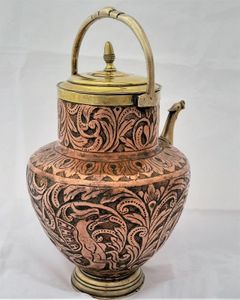 An antique Italian Tuscan repousse copper mezzina water carrier with brass fittings decorated with Cockatrice and acanthus leaf scrolls in an Arts and Crafts style circa 1900
