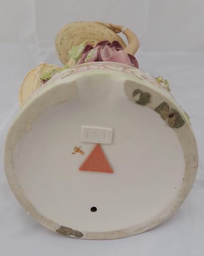 An antique Royal Dux Porcelain Figurine of a female eastern water carrier model number 651 circa 1910.The figure has the very pleasing, muted colour palette of Royal Dux of this period and accentuated with soft gilding. Applied Pink Triangle mark.