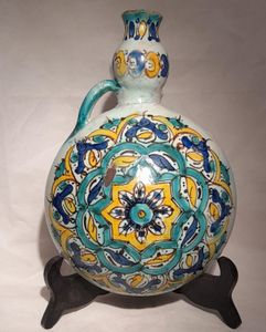 Moroccan tin glazed earthenware or faience pilgrim water flask antique 19th century hand painted with polychrome Arabesque foliate geometric pattern  727 grammes  9 inches long 6.5 inches wide  3 5/8 inches deep