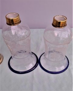 Pair of antique brass spring loaded hurricane candlesticks with grapevine etched glass shades with blue rim & cut glass prism lustre droppers 53 cm High 3.8 kg