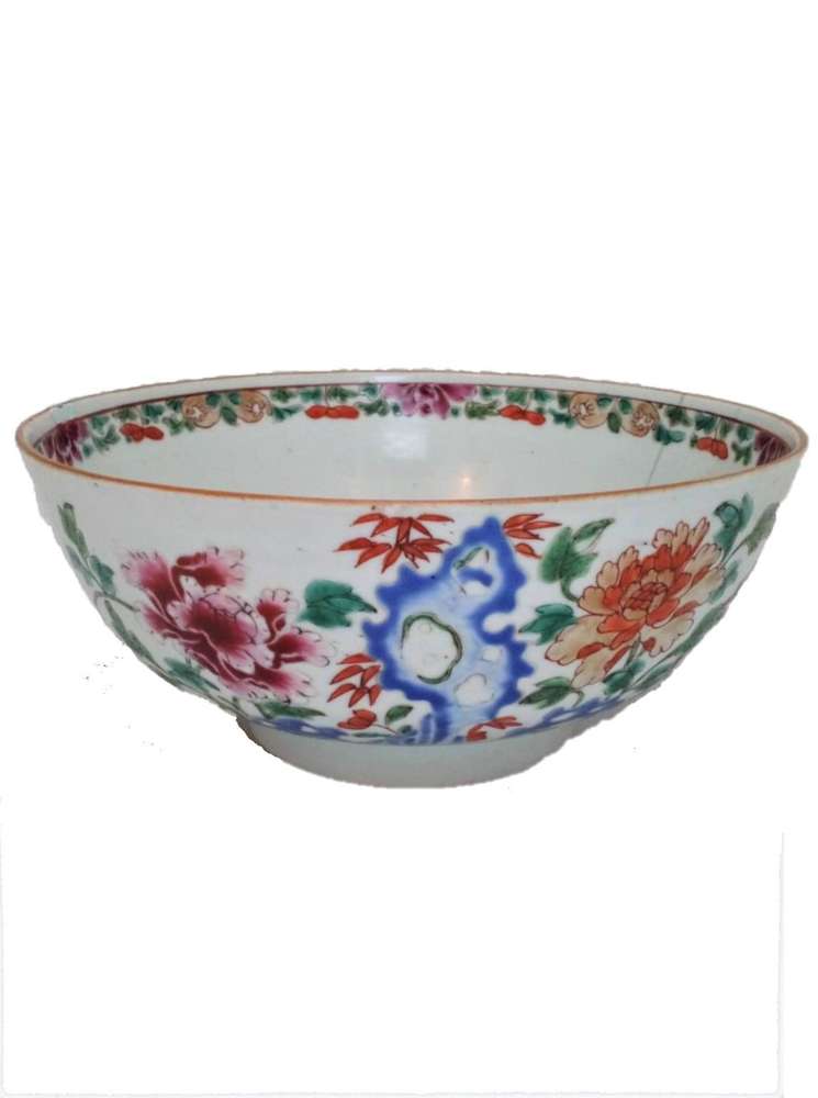 A beautiful antique Qing dynasty 清代 18th Century Kangxi 康熙 era Chinese Porcelain Bowl decorated in hand painted enamels in the Famille Rose palette with a hollow blue rock, peonies, bamboo and Lingzhi fungus, circa 1710.
