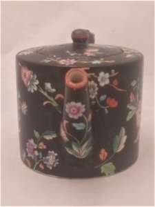 Antique Davenport transferware cylindrical teapot  decorated with the Chrysanthemum Floral Spray pattern on a black ground circa 1860