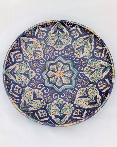 A highly decorative and useful large Islamic floral geometric pattern hand painted bowl charger or wall plate probably North African Moroccan but may be Iznik early 20th century vintage.
