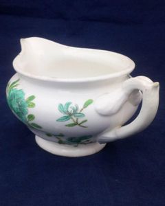 Antique low round porcelain creamer or milk jug made by John Rose of  Coalport Porcelain Works with transfer printed and hand coloured turquoise and green flowers pattern. Dates to circa 1820.