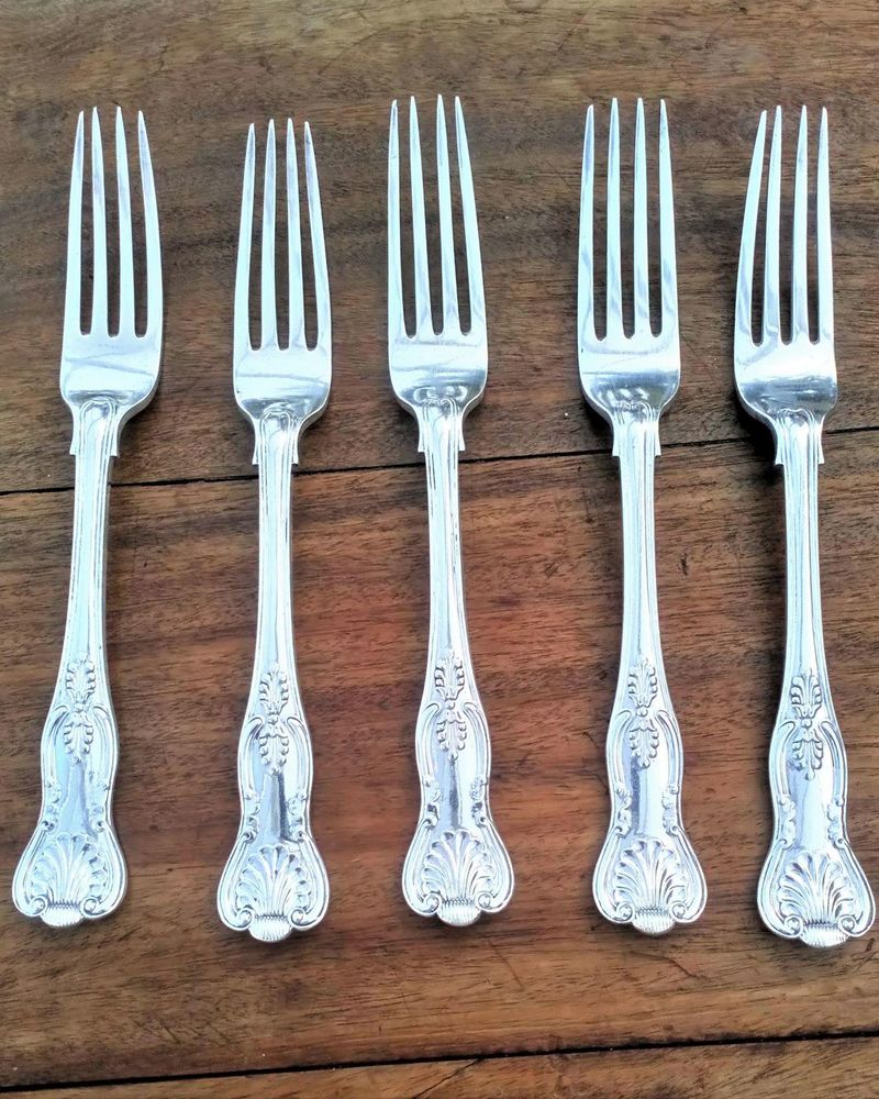 Antique Elkington silver plated set of five large dinner forks made in one piece with shell and anthemion motifs, a pattern known as the king's pattern fully marked with their trade marks and date code W in a square with canted corners for 1884.