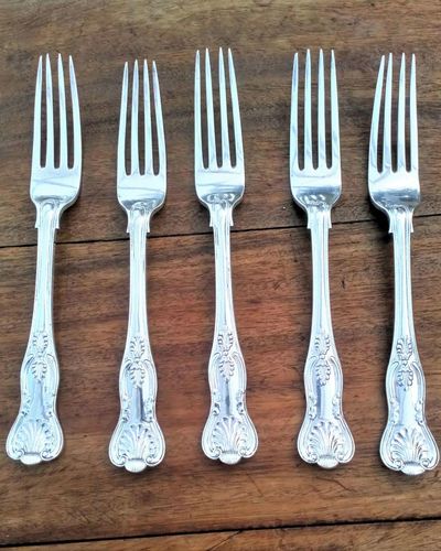 Antique Elkington silver plated set of five large dinner forks made in one piece with shell and anthemion motifs, a pattern known as the king's pattern fully marked with their trade marks and date code W in a square with canted corners for 1884.