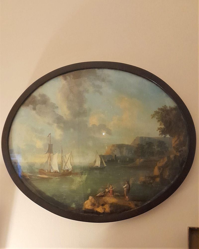 An antique 19th century Grand Tour memento - a Neapolitan oil painting behind convex glass (fixé-sous-verre : the Bay of Naples and Castel dell'Ovo seascape in an oval mahogany frame 49.5 cm by 41 cm