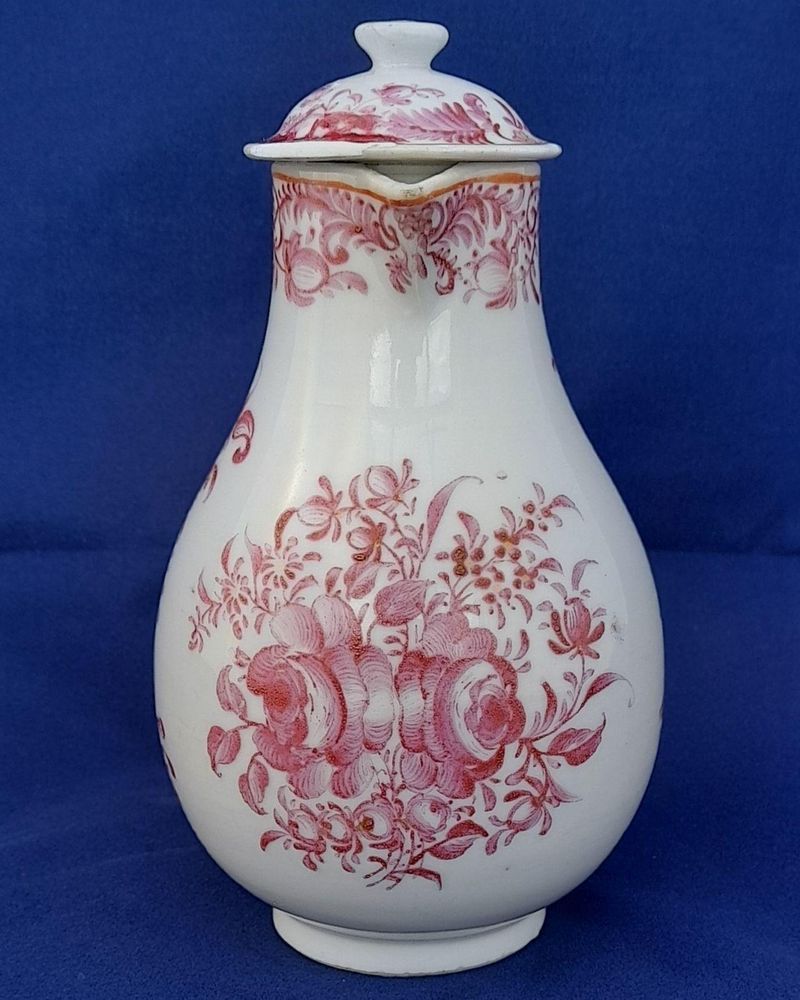 An antique Chinese porcelain lidded sparrow beak milk jug or creamer hand painted in puce with a floral pattern made in theperiod of the Chinese Emperor Qianlong in the Qing dynasty  circa 1760