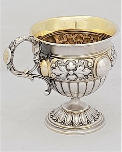 Early 19th century Silver gilt vermiel French Empire style campana shaped cup with ornate floriate repousse decoration sea serpent handle unmarked