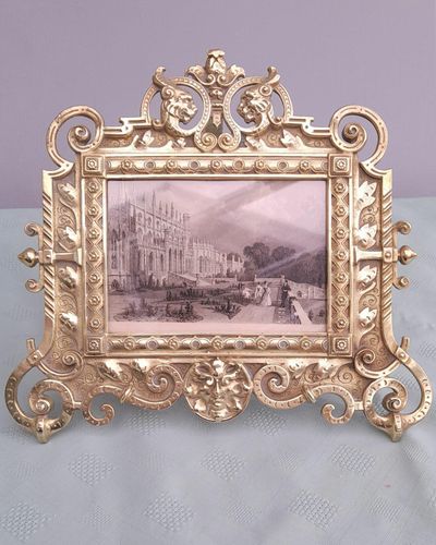 Antique Gothic Revival easel photo picture frame in high relief cast brass - decorated with helmeted leopards, the green man's head & ornate scrolls - for a landscape image size 6" x 4.5" - frame size 9" high, 10 inches wide by 8 inches deep, 19th century circa 1860. weighs 1156 grammes unpacked.