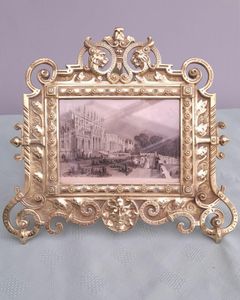 Antique Gothic Revival easel photo picture frame in high relief cast brass - decorated with helmeted leopards, the green man's head & ornate scrolls - for a landscape image size 6" x 4.5" - frame size 9" high, 10 inches wide by 8 inches deep, 19th century circa 1860. weighs 1156 grammes unpacked.