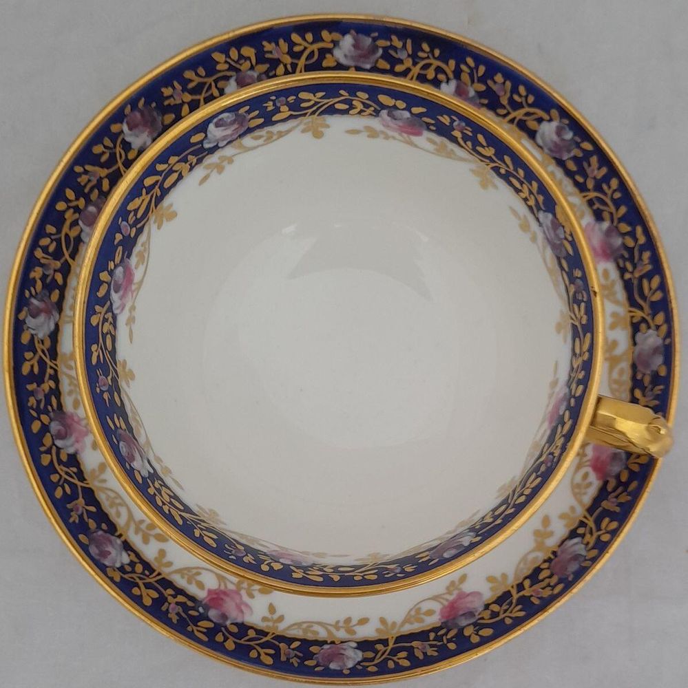 top view cup on the saucer - Antique porcelain tea cup & saucer hand painted blue rim & swagged pink roses by W. Lambert 1915 - Larcombe King St Derby on a Bishop & Stonier Blank