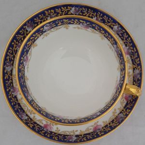 top view cup on the saucer - Antique porcelain tea cup & saucer hand painted blue rim & swagged pink roses by W. Lambert 1915 - Larcombe King St Derby on a Bishop & Stonier Blank