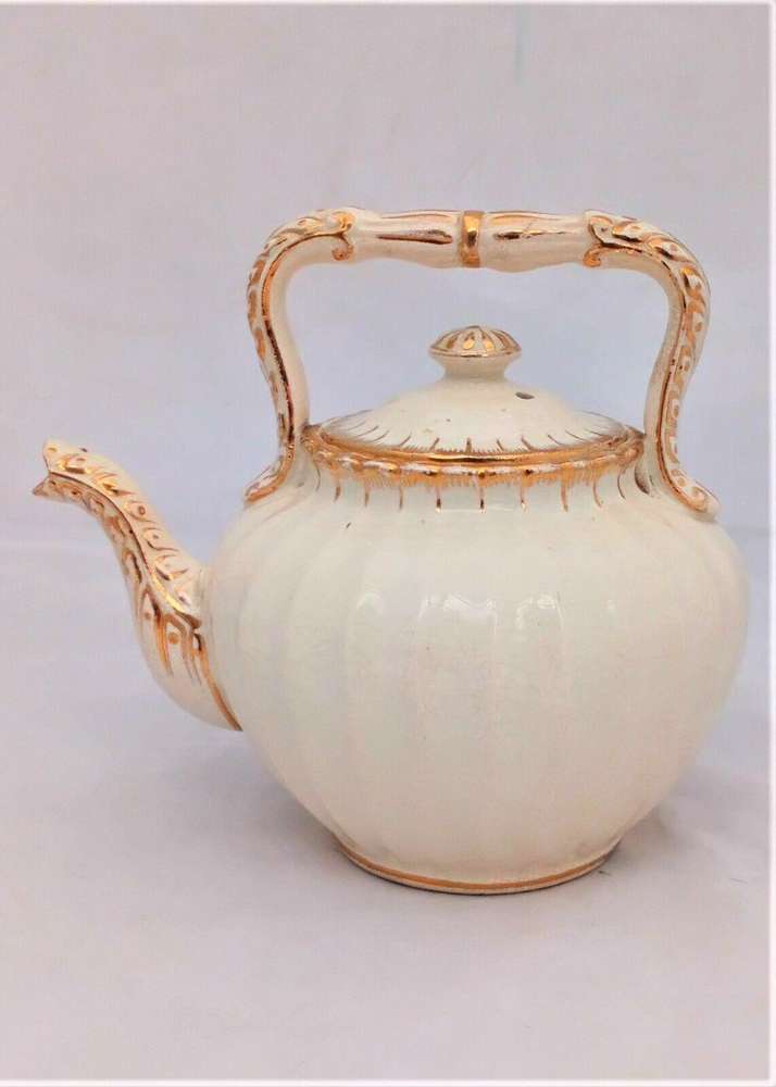 Antique creamware tea kettle shaped teapot with a ribbed  body and opulently gilded in a bachelor size circa 1870