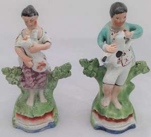 Antique Pair of Enamelled Pearlware Sherratt Style Bocage Figurines of Shepherd with Dog and Shepherdess with lamb circa 1820