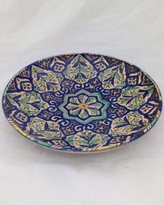 A highly decorative and useful large Islamic floral geometric pattern hand painted bowl charger or wall plate probably North African Moroccan but may be Iznik early 20th century vintage.