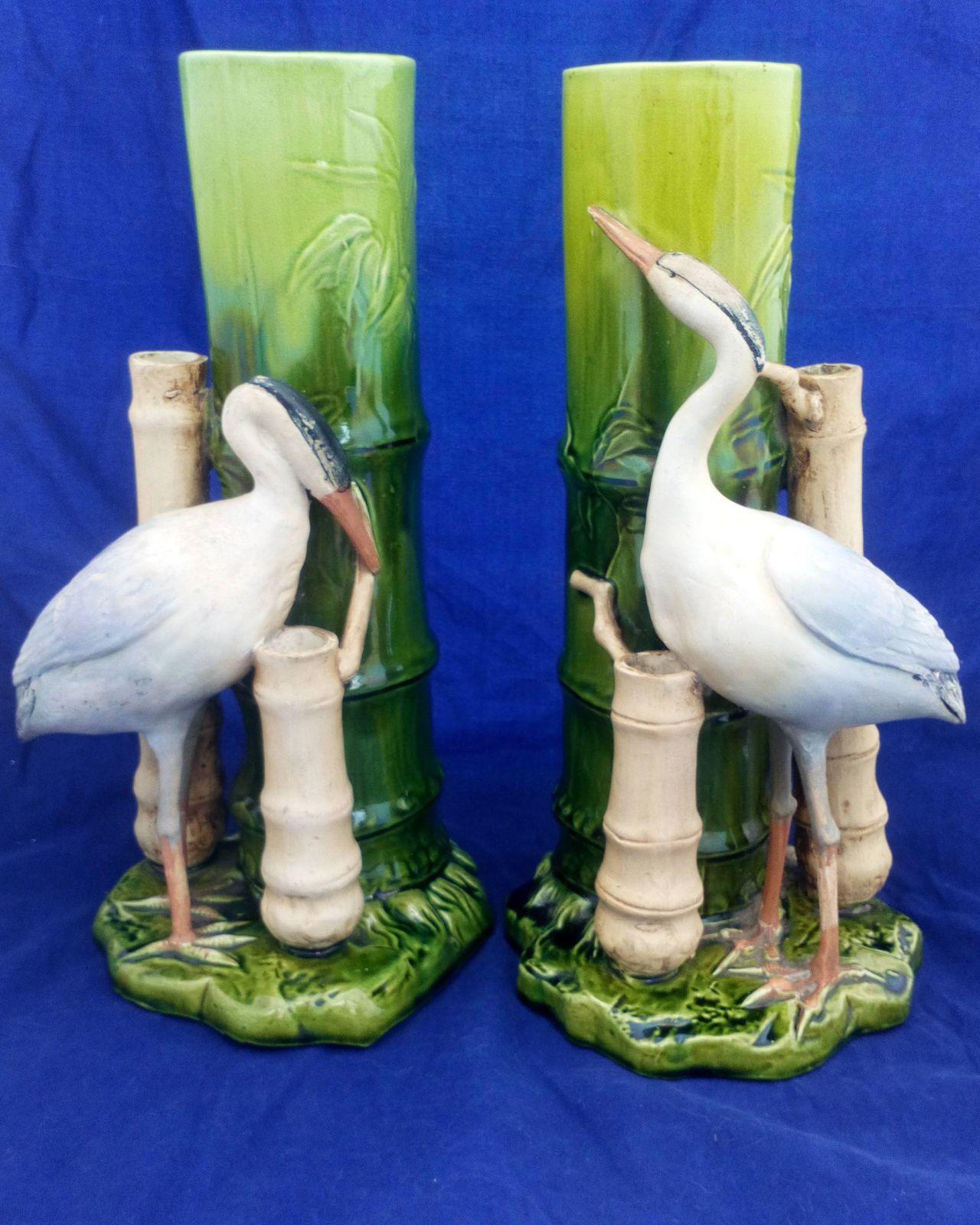 An antique pair of Bretby Art Pottery majolica flower vases or spill holders modelled as bamboo canes each with an oriental crane birds  made by Henry Tooth & Co circa 1895.