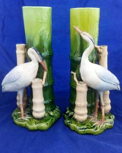 An antique pair of Bretby Art Pottery majolica flower vases or spill holders modelled as bamboo canes each with an oriental crane birds  made by Henry Tooth & Co circa 1895.