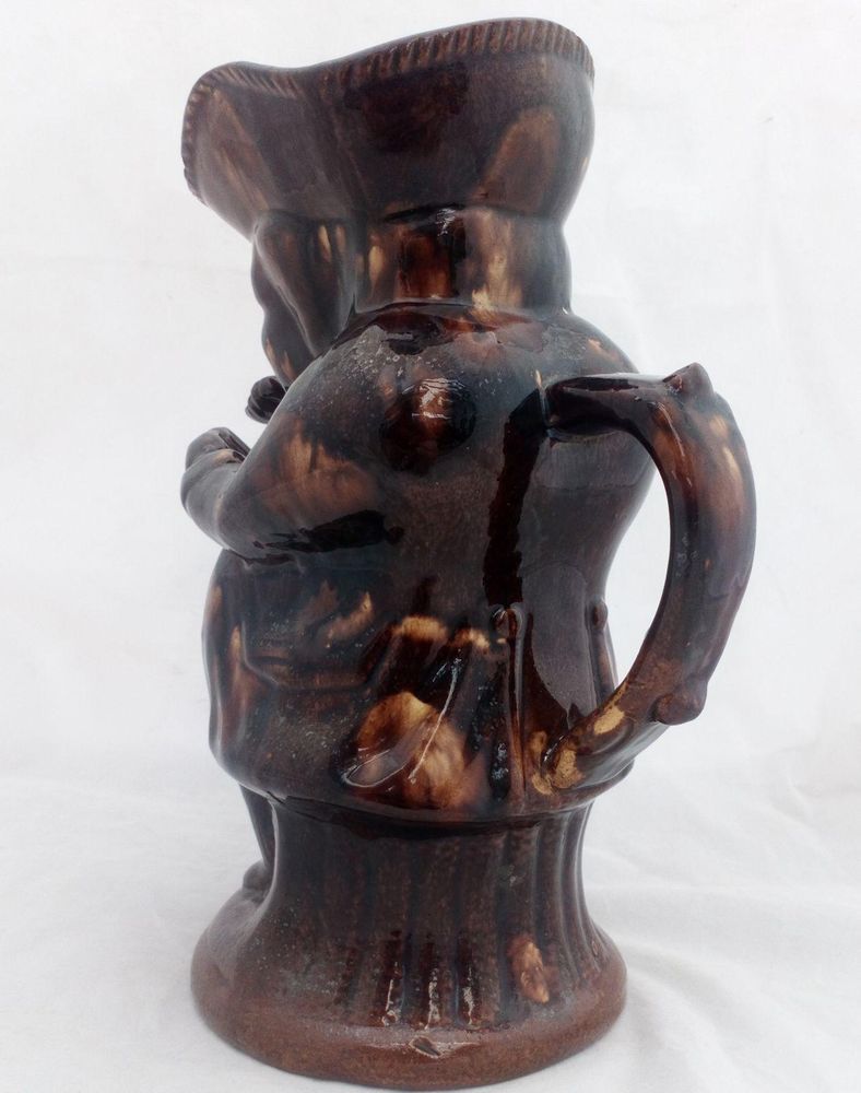 Antique pottery Rockingham brown treacle glazed toby jug known as the Snuff Taker 24 cm high dating from the 19th century circa 1880.