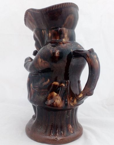 Antique pottery Rockingham brown treacle glazed toby jug known as the Snuff Taker 24 cm high dating from the 19th century circa 1880.