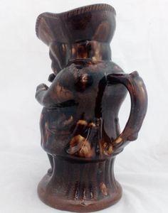 Antique pottery Rockingham brown treacle glazed toby jug known as the Snuff Taker 24 cm high dating from the 19th century circa 1880.