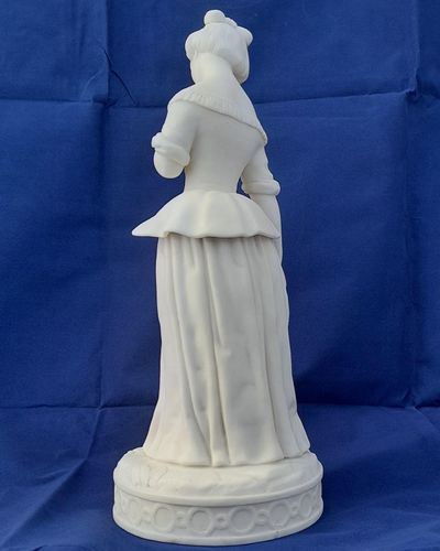 An antique Minton white Parian porcelain figurine of a young woman holding a bird symbolic of kindness and innocence circa 1845 29.5 cm high 1 kg in weight some collectors may refer to this as biscuit or bisque porcelain.