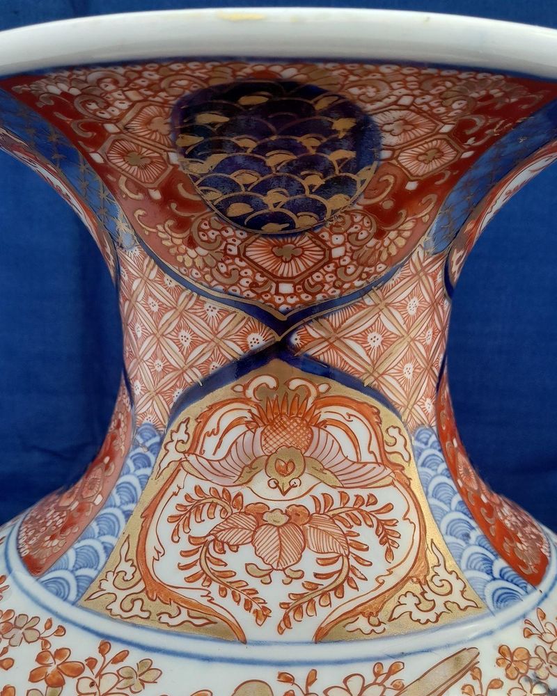A large, 42.8 cm, Japanese Arita or Imari export porcelain baluster shaped vase with a ribbed body and flared trumpet neck, dating from the Meiji period in the latter half of the 19th century.